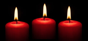 A single red candle burning in darkness, symbolizing passion and focus in a love spell ritual